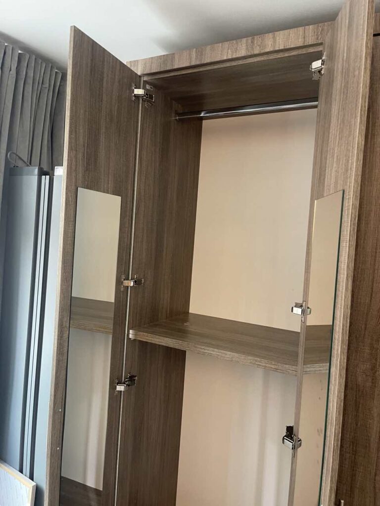 Custom Bedroom Entertainment Center with Integrated Wardrobes for Manhattan Apartment