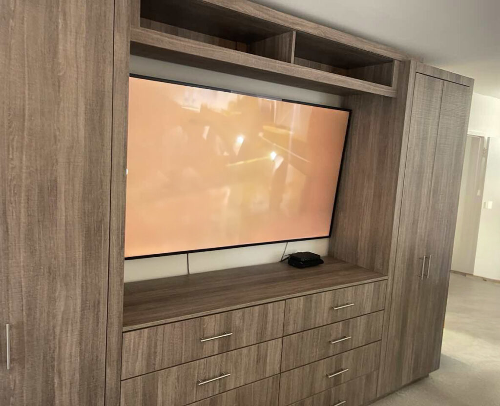 Custom Bedroom Entertainment Center with Integrated Wardrobes for Manhattan Apartment