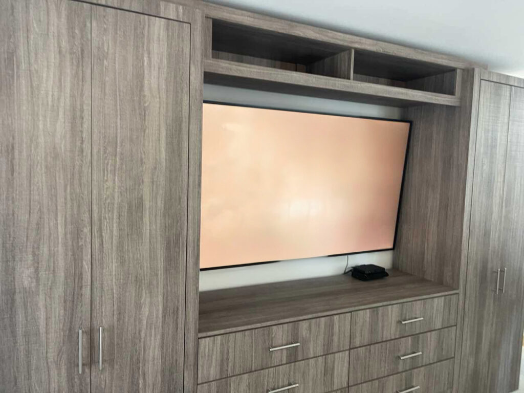Custom Bedroom Entertainment Center with Integrated Wardrobes for Manhattan Apartment