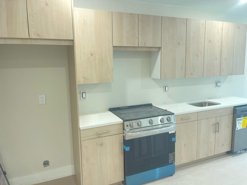 Custom Multi-Unit Kitchen Cabinets: Light Wood Grain with Bronze Accents