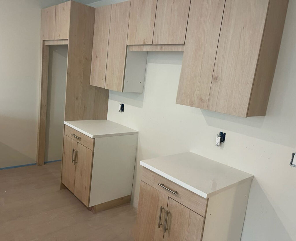 Custom Multi-Unit Kitchen Cabinets: Light Wood Grain with Bronze Accents