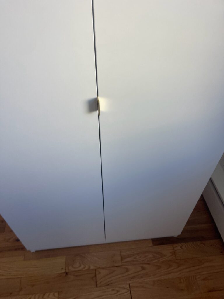 L-shaped brass handles on an Extended-Height Alta Wardrobes